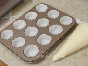 将纸杯套在模具上，蛋糕糊装进裱花袋。