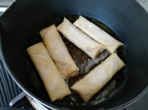 炸锅内倒入多一点菜籽油烧热，放入做好的春卷。