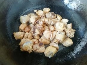 炒锅内倒入适量的菜籽油烧热，先下入糖小火炒出糖色，然后下入鸡腿肉翻炒均匀。