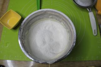 均匀倒入提前过筛好的低粉，千万不要把粉倒在一个地方，太重的话会把面糊压消泡。一定要均匀分散在整个蛋糊表面。