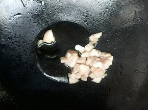 锅中倒入玉米油开小火，油温七成热开大火放入猪肉丁炒熟
