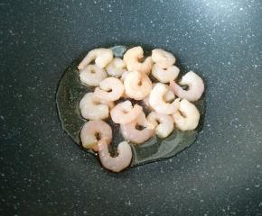 炒锅内倒适量的食用油烧热，下入腌制好的虾仁。