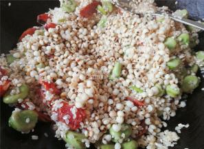 撒入1勺生抽，让米粒上色，再把清洗的薏米倒入一起翻炒，增加不同口感。