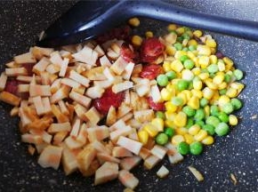 接着把玉米青豆，鱼豆腐倒入翻炒下，撒入少许盐继续翻炒。