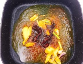 然后下入干锅调料，花椒油炒香