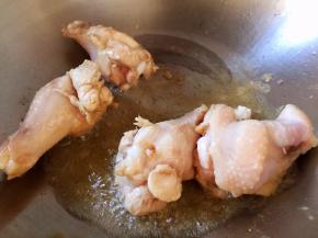 油锅烧热，放入鸡翅根翻炒片刻