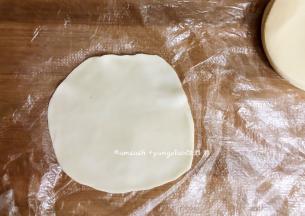 取一个饺子皮，把饺子皮擀薄