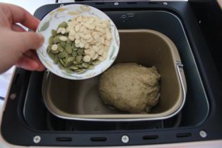 打开面包机盖，倒入瓜子仁。盖盖，继续直到程序结束，吐司烤好。全程不需要暂停。