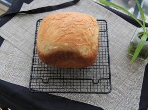 双手带隔热手套拿住面包桶，把吐司倒出来即可。如果搅拌叶片留在吐司上，可以等冷却后再取出。