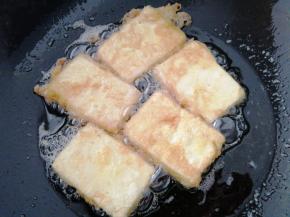 锅里放油，油温6成热的时候，把豆腐放进去，炸制两面金黄，一定要小火炸，不然会糊了。