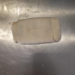 把水油皮捏合起来，包住油酥，尽量挤出里面的空气。