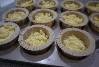 把蛋糕糊装入裱花袋，挤入马芬杯子中。约8分满，然后撒上酥粒。