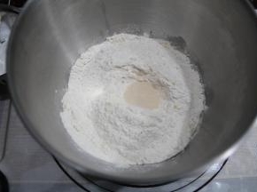 厨师机打面桶中，先液体，糖和盐分开两个角落，再放高粉，酵母在高粉上挖洞放入。