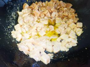 放腌制好的鸡丁快速翻炒。