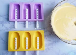 备雪糕模具把芒果雪糕糊倒入模具中填满。