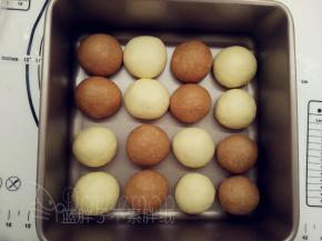 除做耳朵、手脚和爱心的三个小面团外  ，其余松弛好的面团压扁之后再次滚圆，一一摆入学厨8.5寸活底正方形模中。