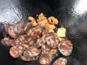 加入腊肠，煎炒至变色