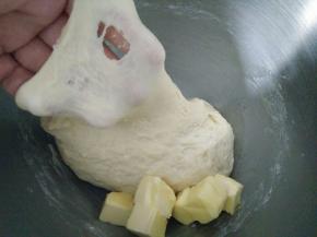 面团材料除黄油外全部放在一起，揉成面团，揉至面团表面光滑，能拉出较厚的膜加入黄油。
