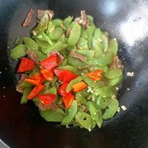 大约两分钟左右，再倒入红椒片翻拌均匀继续盖上盖子焖煮一分钟左右。全程不需要家一滴水焖煮