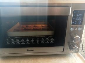 紫薯芝麻饼放入烤箱中下层，上下火160度烤15分钟，如果没有烤箱，可以放不粘锅里小火煎到两面有些发黄