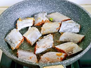 起油锅，将腌制好的带鱼段摆放在锅中。