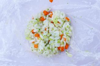 取一块保鲜膜，将饭团放入保鲜膜中压扁。