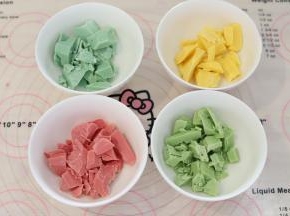 四色色巧克力分贝切成小块，放入碗中。