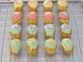 稍干的时候放上彩色的食用糖珠装饰。按刚才的方法做好所有颜色的玛德琳。