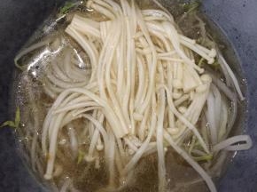 把豆芽和金针菇放在一大碗中，把煮好的酸汤倒入。