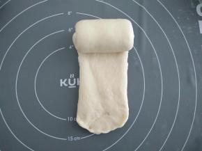 再将面团擀长，尽量宽度均匀，由上往下卷起，收口处用擀面杖擀的薄一点，收口朝下，记住不要卷太紧，依次做好放入模具。