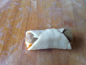 然后两边分别折叠上来捏紧口，如图把它们包起来