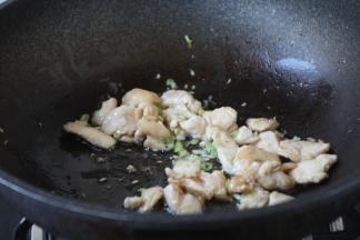 放入鸡肉，炒至颜色变白。