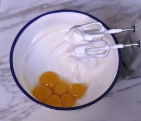 然后加入蛋黄，低速打匀，继续加入玉米油和牛奶搅拌均匀