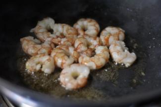 起热锅入油，将腌好的虾仁滑熟捞出