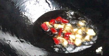 锅烧热油，爆香蒜末和小米辣