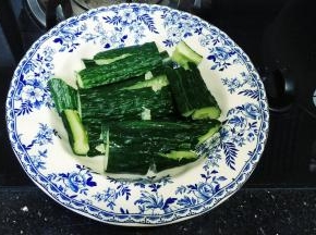 青瓜切段拍碎放入盘子里