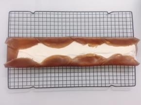 把饼皮一张叠一张的铺开，抹上淡奶油。两端和边边如图卷起来