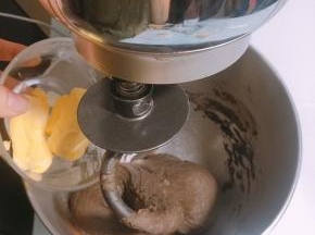 面团表面揉至光滑后加入软化的黄油，开低档揉至黄油完全融合于面团