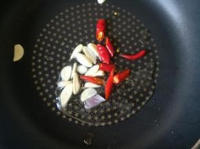 热锅凉油，下入大蒜和小米辣煸香