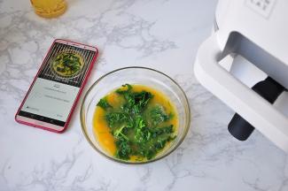 热锅结束，手机APP提示下一步需要加入的食材，用多少量，放多少盐都有菜单指示，您只需按要求操作就行。我按照提示，将切碎的芹菜叶放在蛋液中。您不必手忙脚 乱，每一步机器都会发出提示鸣音，并且在手机上有显示，您添加确认后才能进行下一步。