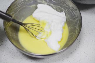 挖三分之一蛋白霜加入蛋黄面糊中。