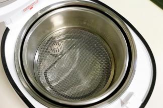 往臻米电饭煲不锈钢内胆中安装甄子和小滤网。