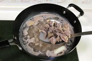 锅中倒入适量的清水，放入切好的牛腩，倒入1勺料酒，放1段大葱和2片姜，开火煮沸后捞出，用清水冲洗干净。