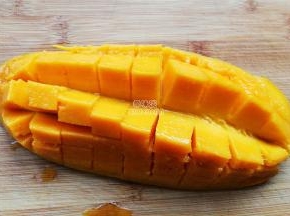 首先把芒果切半，取下果肉装入食品袋，冰箱里冷冻备用。