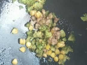 锅中放入黄油块，开中火，融化后加入猪肉炒熟。加入玉米粒和西兰花、盐炒熟盛出。