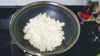 锅里热油放入剩米饭