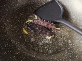 热锅倒入熬制好的葱油，升温后把姜丝爆香，把沥干的海参倒入。