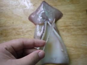 鱿鱼清洗干净后挤去眼睛、牙齿和鱿鱼须上白色的吸盘，剖腹，去除内脏和软骨。
