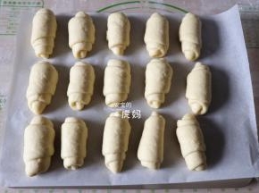 一一卷好收口朝下放入烤盘，放入烤箱进行二次发酵，发酵50-60分钟左右；