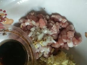 猪肉切丁，加入葱姜末、盐、生抽搅拌均匀腌制10分钟。
